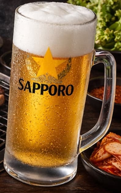 Cold Sapporo mug served beside the barbecue